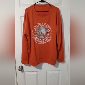 Vibrant Orange Long Sleeve Top with Graphic Design